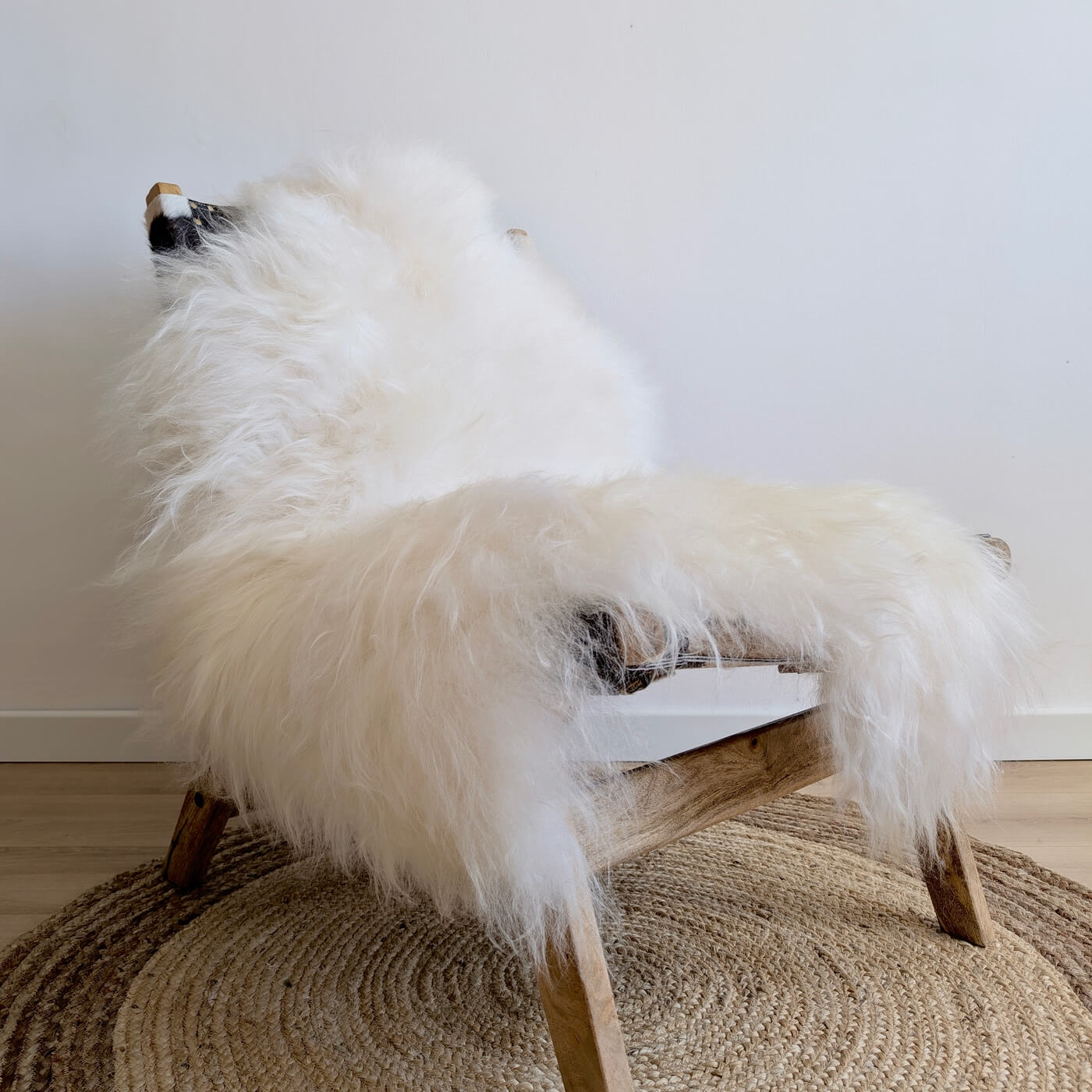 Covor din blana de oaie islandeza extrem de pufos si dens, cu fir extra lung de minim 10 cm, de culoare alba ivory, pe fotoliu